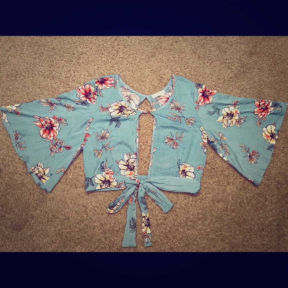 Greenish floral blouse w/ open back and front.